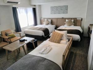 a hotel room with three beds and a table at HOTEL MYSTAYS Kiyosumi Shirakawa in Tokyo +27 photos