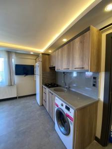 a kitchen with a washing machine and a sink at theblue suıt otel cafe restaurant in Mudanya