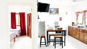 a kitchen with a table and chairs in a room at Anse Grosse Roche Beach Villa in La Digue