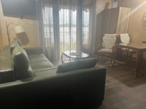 a living room with a couch and a table at Dunavska Kuća in Smederevo