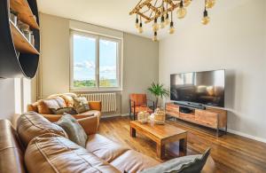 a living room with a couch and a tv at La Maison du Douanier Apach in Apach