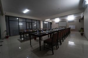 a large meeting room with a long table and chairs at Paragon Hotel & Resort in Sreemangal +32 photos
