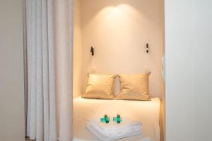 a bedroom with a white bed with two candles on it at Luxurious studio with a stunning view in Middelkerke