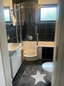 a bathroom with a tub and a sink and a toilet at Ferienhaus Mathilda in Kusel
