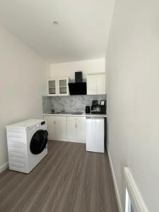 a kitchen with white cabinets and a microwave at Deerpark 3 bed semi Sleeps 6 & Optional extra outdoor sauna in Cashel