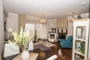 a living room with a vase of flowers on a table at Evmorfes Villas in Polygryos