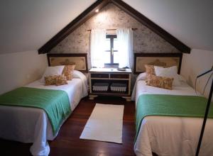 A bed or beds in a room at Hotel Rural Cabo Busto