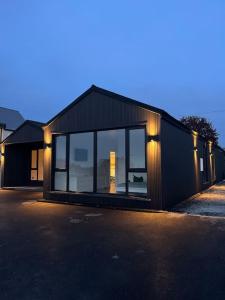 a black house with lights on the side of it at Deerpark 3 bed semi in Cashel