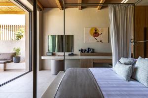 a bedroom with a bed and a desk in a room at Heraklion Cicada Suites & Villas in Karteros +21 photos