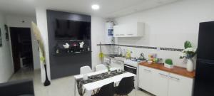 a kitchen with white cabinets and a stove top oven at EL TEMPLE Pampa in San Clemente del Tuyú