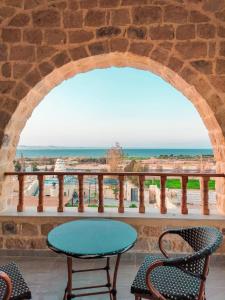 a table and chairs on a balcony with the ocean at فيلا البرج-Villa Elburj in Tunis +14 photos