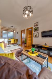 a living room with couches and a table at Blue-Angel-Lux in Zlatibor