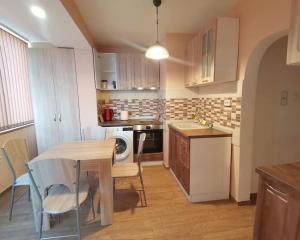 a kitchen with a table and a table and chairs at Danube View in Vidin