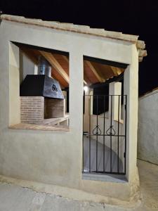 a building with a window with a brick oven at Apartamentos Rurales LA BUENA ESTRELLA in Alcalá del Júcar