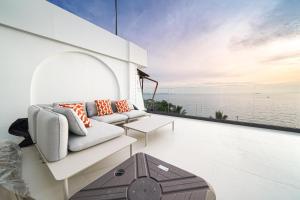a living room with a view of the ocean at Surf Beach House Pool Villa in Na Jomtien