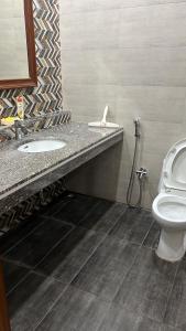 a bathroom with a sink and a toilet at Doctor's house in Lahore