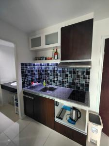 a kitchen with a sink and a counter top at Blue and green Farang homes in Chiang Mai