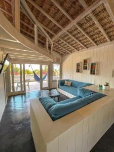 a living room with a large blue couch in a room at Nordestina Loft in Icaraí +33 photos
