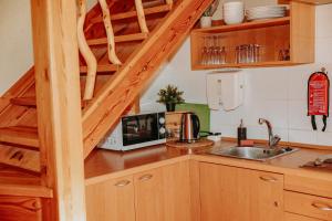 a kitchen with a sink and a microwave at Atpūtas komplekss ''Lācītes'' in Gulbene +15 photos