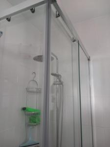 a shower with a glass door in a bathroom at Chalet adosado con piscina in Caleta De Velez