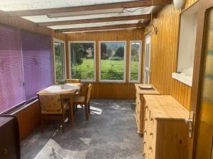 a room with a table and chairs and windows at Ferienwohnung 90qm max 3 Gäste in Coppenbrügge