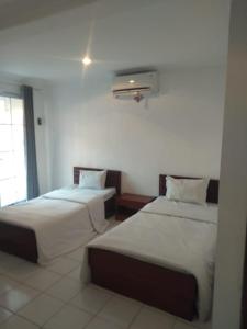 Ένα ή περισσότερα κρεβάτια σε δωμάτιο στο Hotel Candrakirana