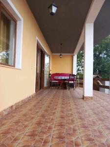 an empty patio with a table and chairs on it at Casa Rasaritul Soarelui Sarichioi in Sarichioi
