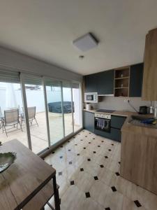a kitchen with a view of a patio at Maison Clémence in Cabra del Santo Cristo
