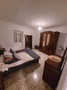 a bedroom with a large bed and a table at Maison Clémence in Cabra del Santo Cristo +50 photos