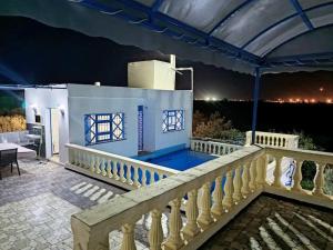 a view of a house from the balcony at night at le petit paradis in Chaba Remada