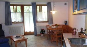 a kitchen and living room with a table and a dining room at Residence Il Giardino in Croviana +19 photos