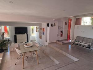 a living room with a table and a couch at La Muralla Roja in Calpe