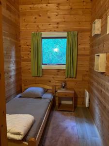 a room with two beds and a window at LES REFUGES DU LOT Kouki's Lodge in Mauroux +14 photos