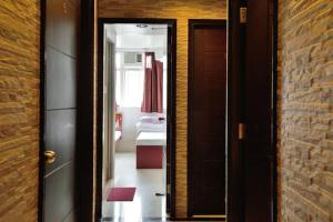 a hallway with a door leading to a bedroom at JW Hostel in Hong Kong