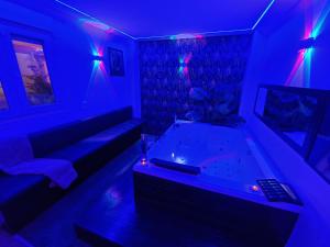 a living room with a tub in a blue room at Sensual Sierra VIP in Prado del Rey +64 photos