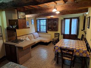 a living room with a couch and a table and a stove at Corte Pincione in Montecarlo +6 photos