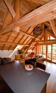 a kitchen and living room with wooden ceilings and a table at Apartment 19 in La Salle Les Alpes +16 photos