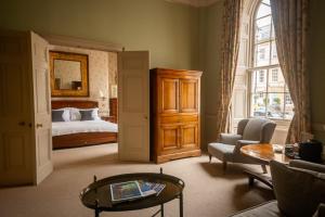 a living room with a bed and a table at Dukes Bath in Bath
