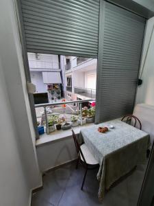 a table and chairs in a room with a window at M&S Apartment in Lezhë +5 photos