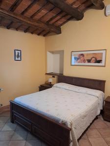 a bedroom with a bed and a picture on the wall at Corte Pincione in Montecarlo