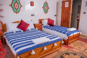 Postel nebo postele na pokoji v ubytování Hotel Awayou