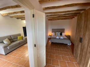 a living room with a couch and a table at Apartament2 Ca la Maru amb jacuzzi comunitari in Sant Antolí i Vilanova +66 photos