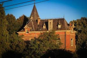 a large brick building with a tower on top of it at B&B Chatelet Cremers in Verviers