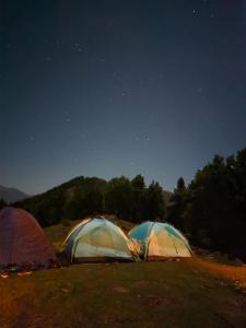 a group of tents in a field under the stars at Outdoor Adventures Camp Pirchanasi in Muzaffarabad