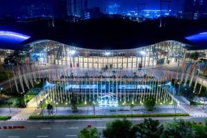 a building with a fountain in front of it at night at natural minimalist apt ice bsd in Cilandak