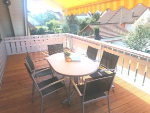 a patio with a table and chairs on a deck at Ferienwohnung Rheintal in Kappel-Grafenhausen