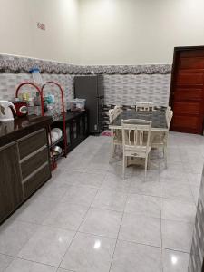 a kitchen with a table and chairs in a room at Larut Tin Homestay in Taiping