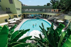 a swimming pool in a hotel with people in it at Hotel Svoboda - Terme Krka in Strunjan