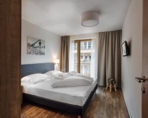 Łóżko lub łóżka w pokoju w obiekcie AlpenParks Hotel & Apartment Central Zell am See