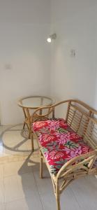two chairs with a table and a glass table with a seat at Surfhouse Boavista in Sal Rei +32 photos